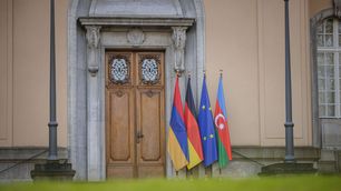 Trilateral meeting at Villa Borsig in Berlin between Germany, Armenia, and Azerbaijan, with their flags displayed alongside the European Union flag at the entrance.