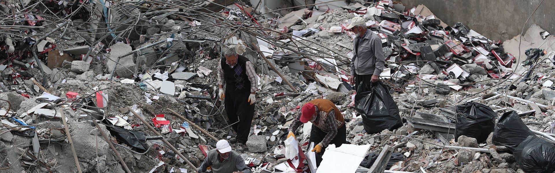 Workers collect useful remains of their stuff from collapsed shops in Kahramanmaras, Turkey.