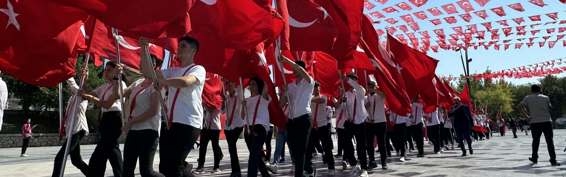 Students with Turkish flags take part in the celebrations of 102nd anniversary of Victory Day and Turkish Armed Forces Day at Istasyon Square in Gaziantep, August 30, 2024