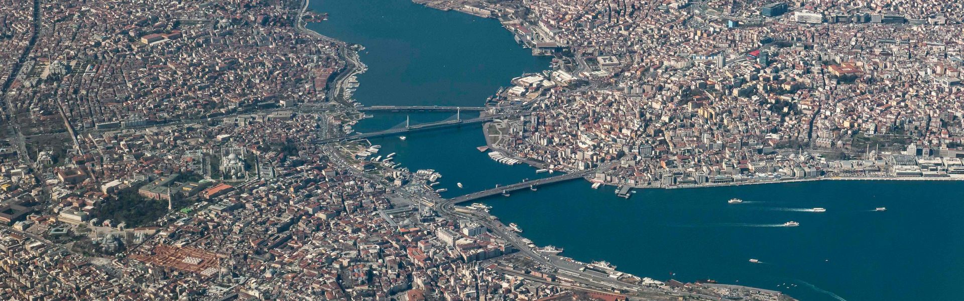 Aerial view of Istanbul, Turkey with World Heritage sites such as Hagia Sophia, Topkapi Palace, Blue Mosque, Galata Bridge and more in the Fatih district between the Golden Horn, the Sea of Marmara and the Bosporus. Aerial view of Istanbul, Turkey with World Heritage sites such as Hagia Sophia, Topkapi Palace, Blue Mosque, Galata Bridge and more in the Fatih district between the Golden Horn, the Sea of Marmara and the Bosporus.